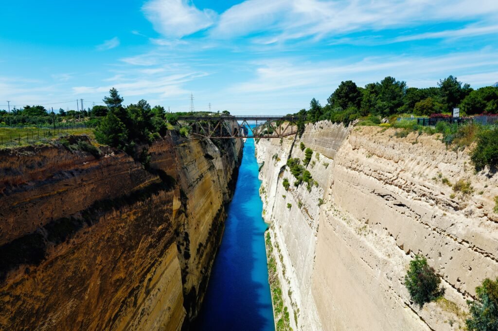 Breathtaking aerial view of the Corinth Canal under a clear blue sky.